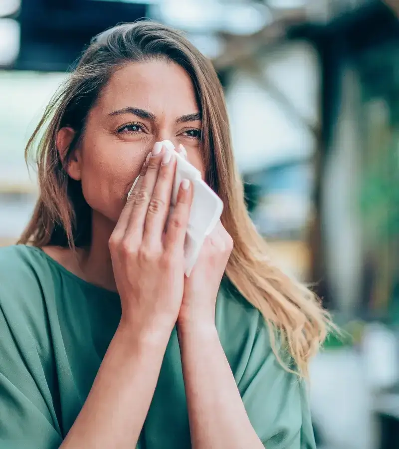 an image of a woman blowing her nose